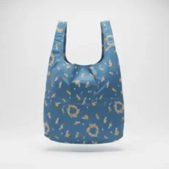 reusable foldable shopping bag with gold print, shown with matching compact pouch.