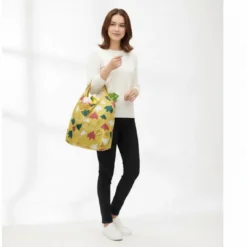 reusable foldable shopping bag with gold print, shown with matching compact pouch.